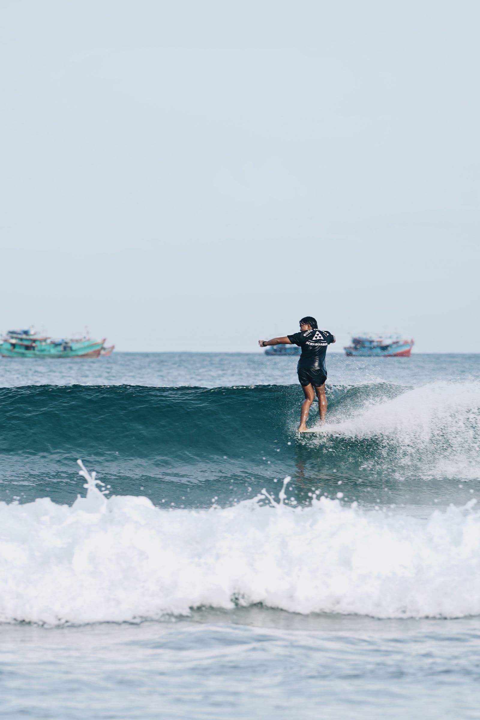 A surfer riding a clean right-hand wave on Sri Lanka's east coast