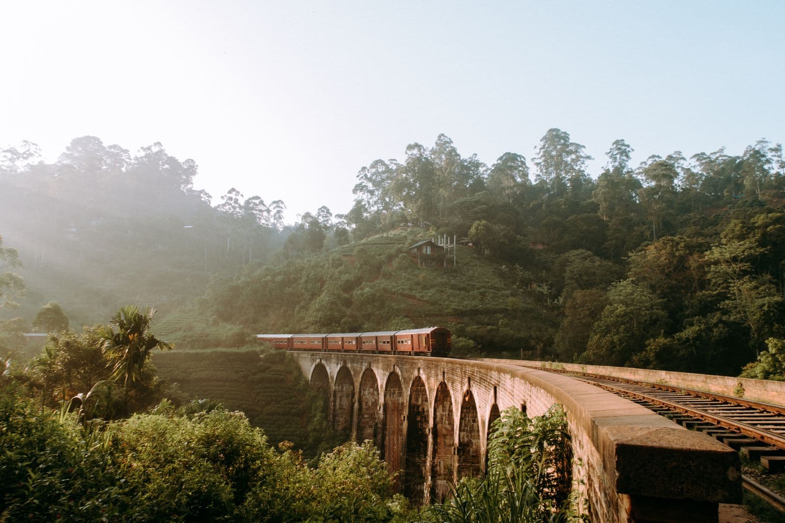The blue Sri Lankan hill country train crossing the Nine Arch Bridge at Ella