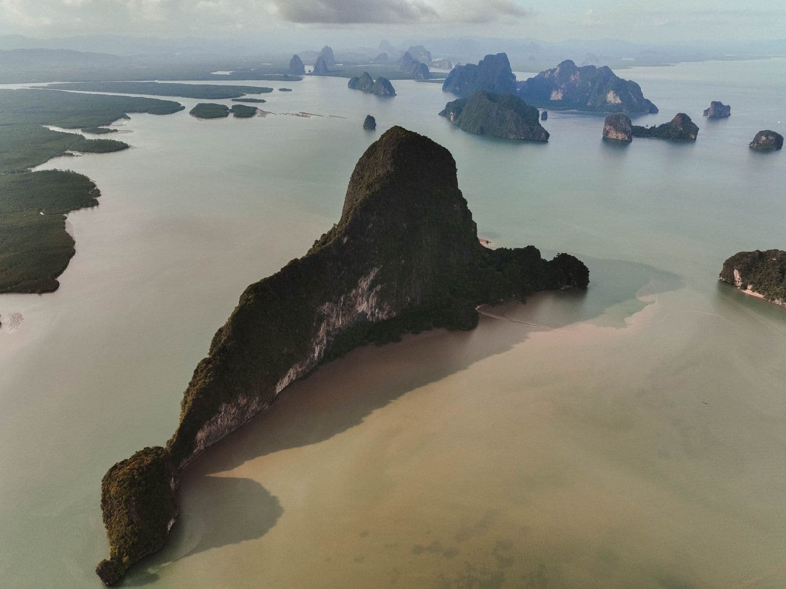 Limestone karst islands rising from green water in Phang Nga Bay, Thailand