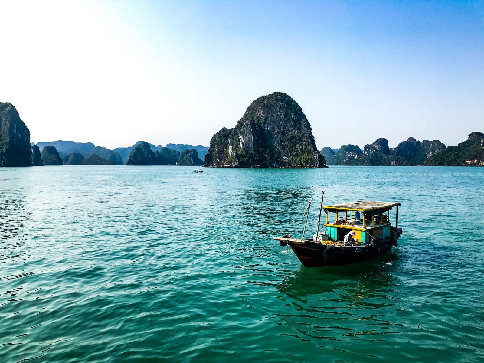 Traditional junk boats among the limestone islands of Ha Long Bay, Vietnam